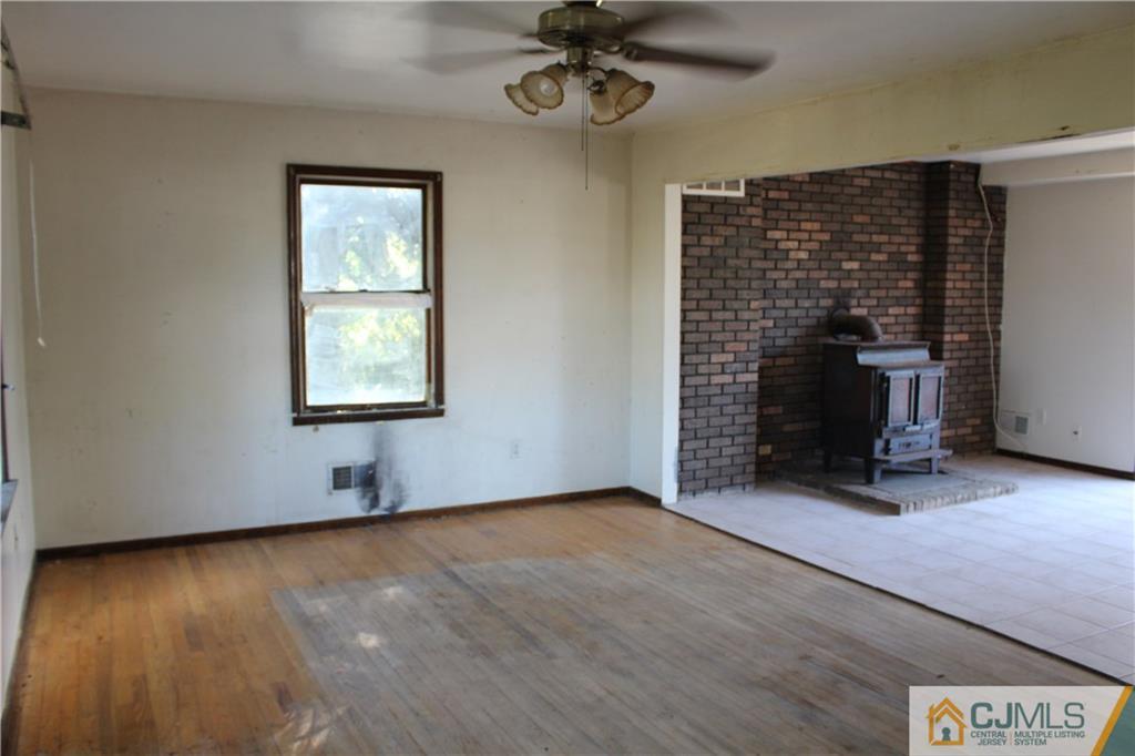 317 Ridge Road Dayton, NJ 08810 - Photo 10 of 16 wooden floor in an empty room with a window
