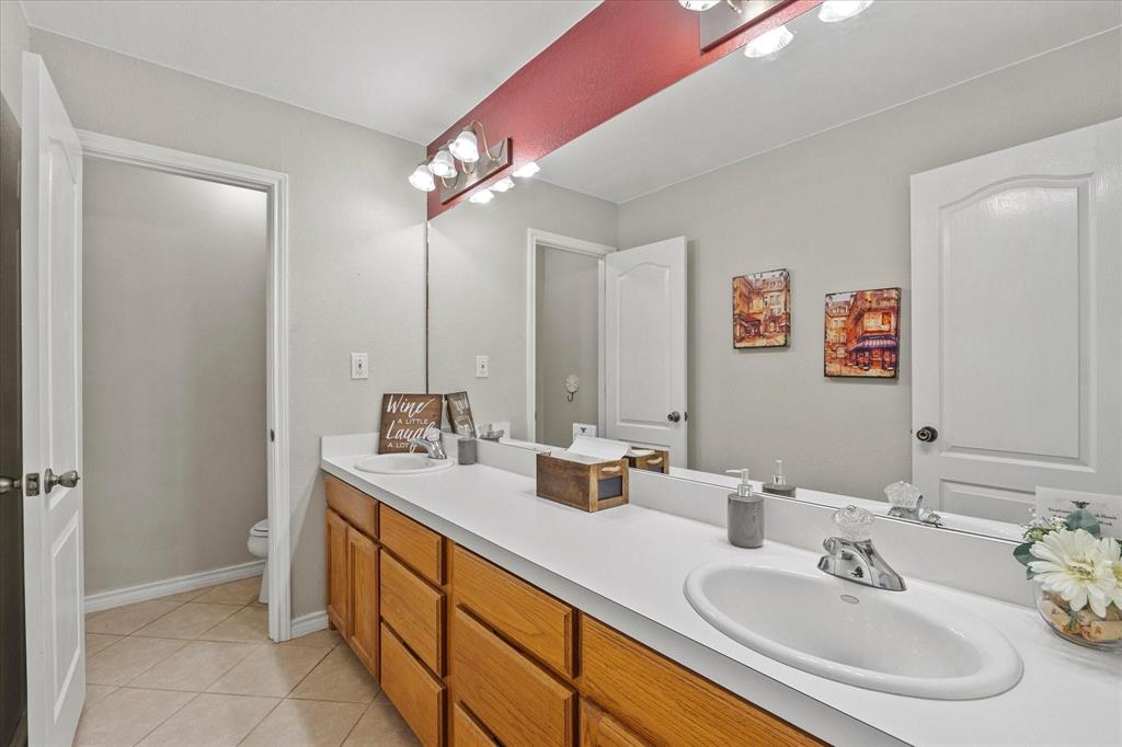 3399 Peterson Road South Iowa Park, TX 76367 - Photo 14 of 40 a bathroom with a sink and a mirror