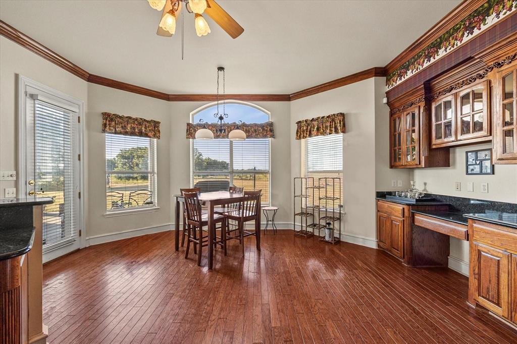 3399 Peterson Road South Iowa Park, TX 76367 - Photo 25 of 40 a view of a dining room with furniture window and wooden floor