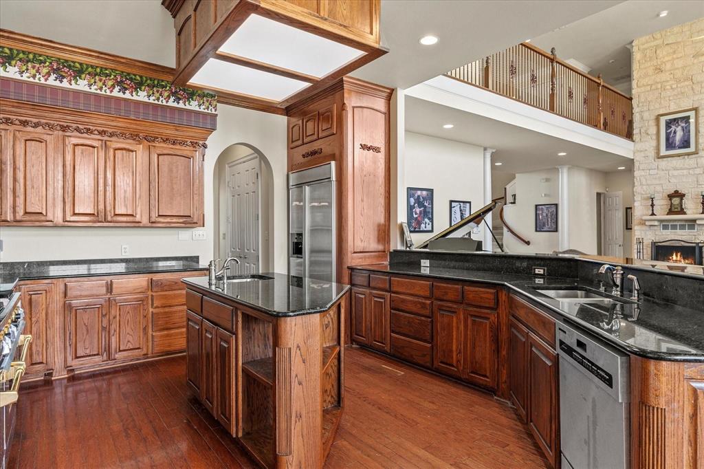3399 Peterson Road South Iowa Park, TX 76367 - Photo 26 of 40 a kitchen with stainless steel appliances granite countertop a sink and wooden cabinets