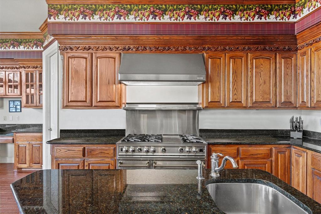 3399 Peterson Road South Iowa Park, TX 76367 - Photo 27 of 40 a kitchen with granite countertop a stove and a sink