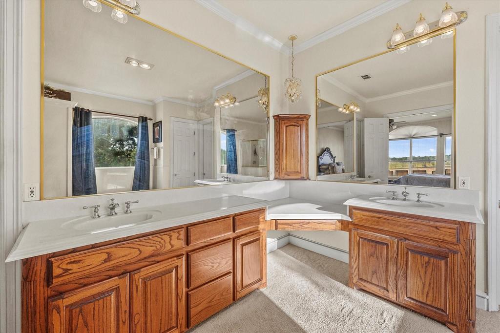3399 Peterson Road South Iowa Park, TX 76367 - Photo 32 of 40 a spacious bathroom with double sink and a large mirror
