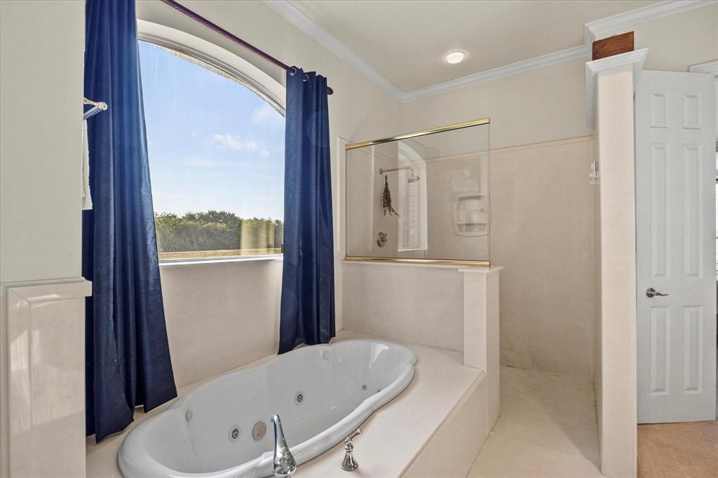 3399 Peterson Road South Iowa Park, TX 76367 - Photo 33 of 40 a bathroom with a bathtub and a shower