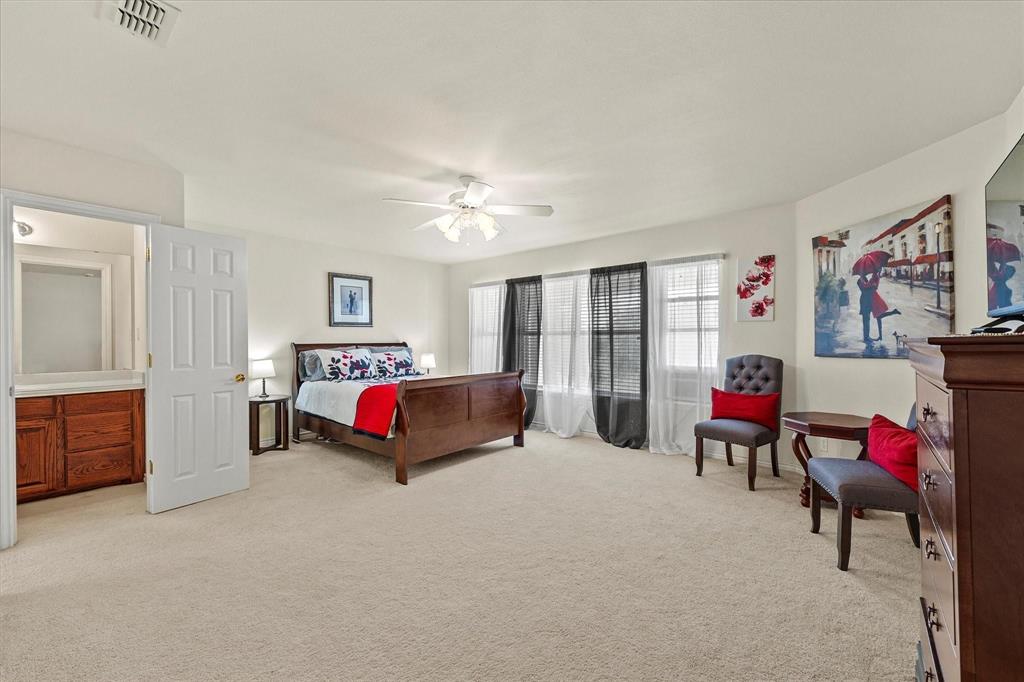 3399 Peterson Road South Iowa Park, TX 76367 - Photo 35 of 40 a bedroom with furniture and a chandelier