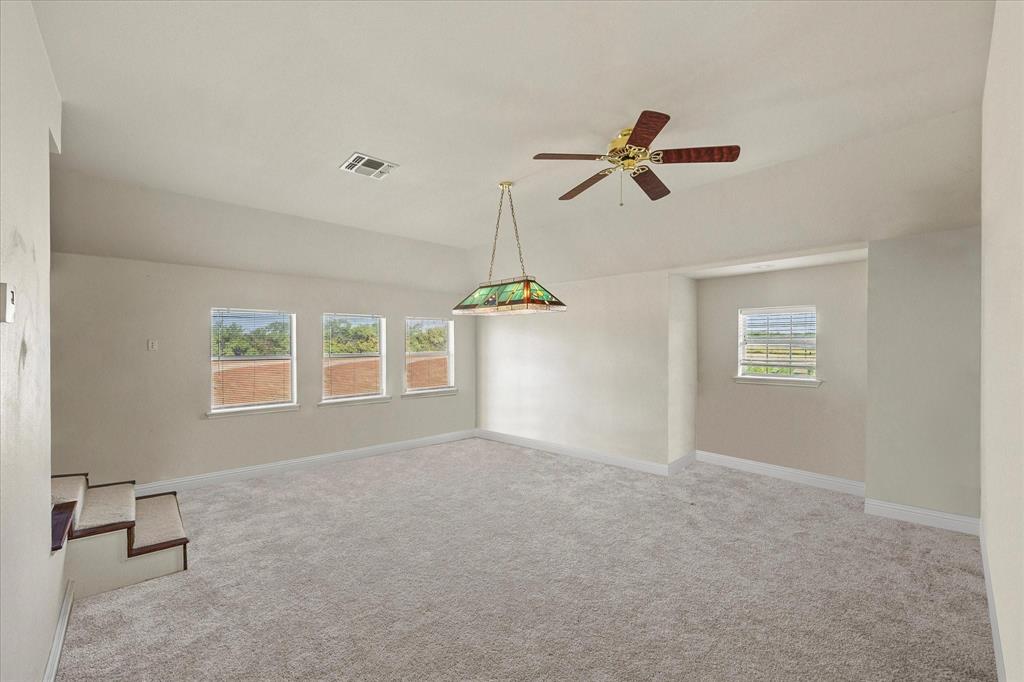 3399 Peterson Road South Iowa Park, TX 76367 - Photo 38 of 40 an empty room with windows and fan