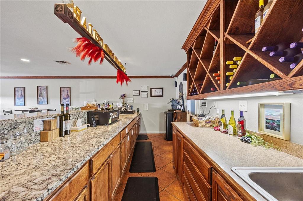 3399 Peterson Road South Iowa Park, TX 76367 - Photo 10 of 40 a kitchen with stainless steel appliances granite countertop a sink stove and cabinets