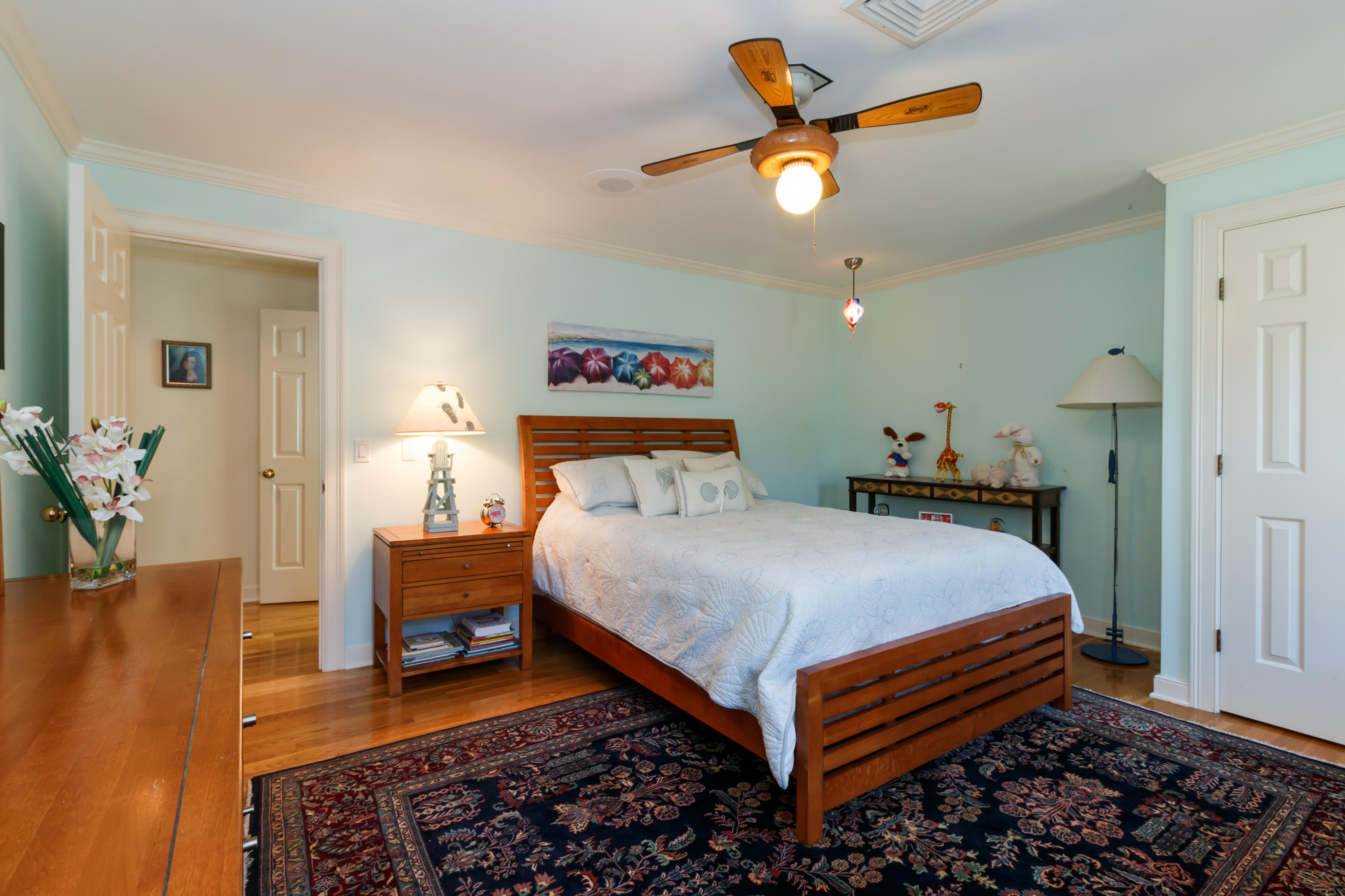 56 Lakeview Drive Centerville, MA 02632 - Photo 22 of 30 a bedroom with a bed and a chandelier