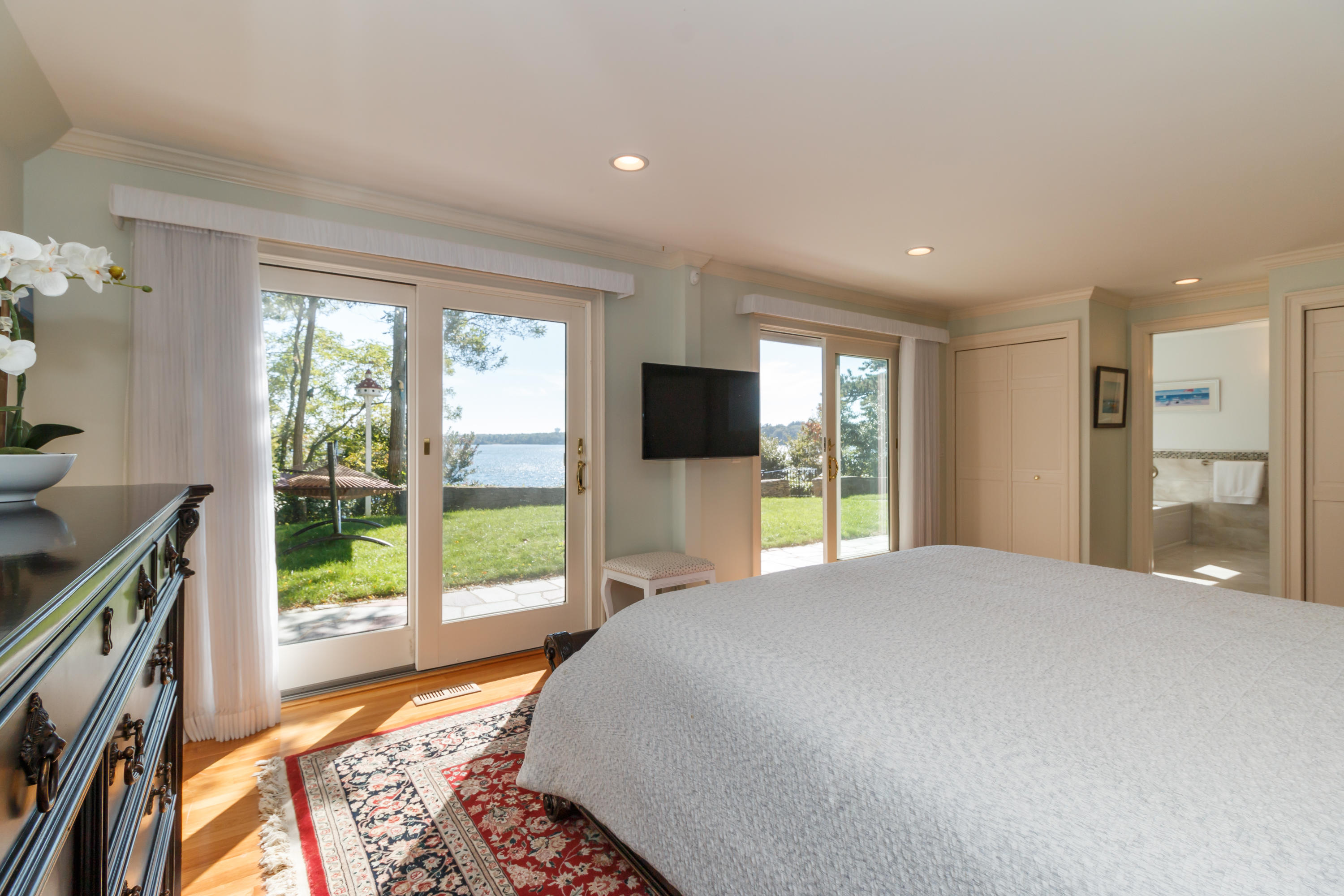 56 Lakeview Drive Centerville, MA 02632 - Photo 7 of 30 a bedroom with a large bed and a flat tv screen on dresser