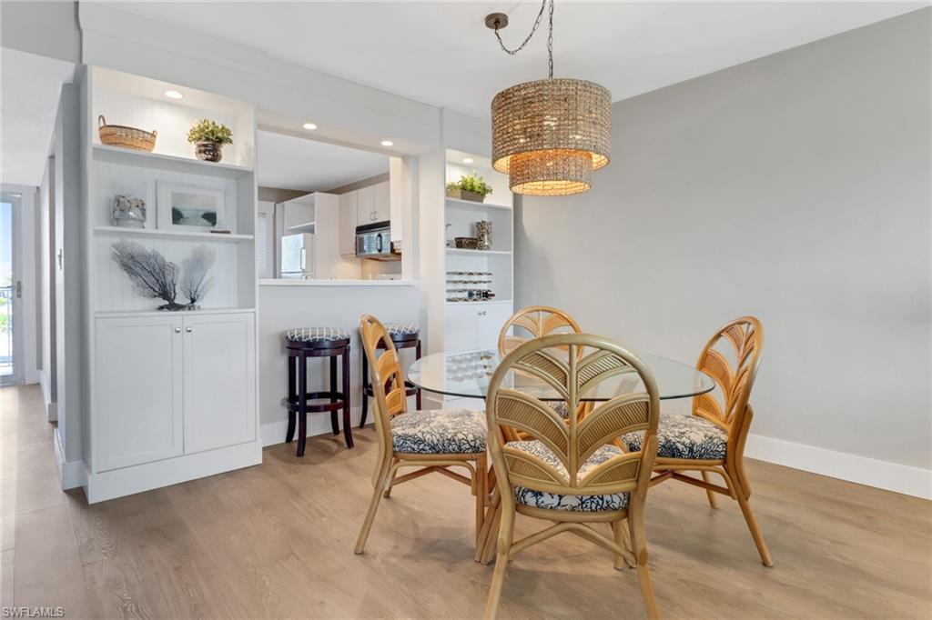 309 Goodlette-Frank Road, Unit A305 Naples, FL 34102 - Photo 4 of 10 Dining space featuring recessed lighting, baseboards, light wood-type flooring, and an inviting chandelier