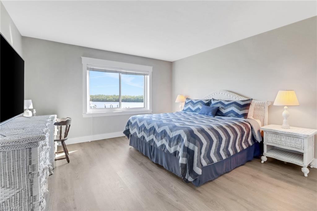 309 Goodlette-Frank Road, Unit A305 Naples, FL 34102 - Photo 6 of 10 Bedroom with wood finished floors and baseboards