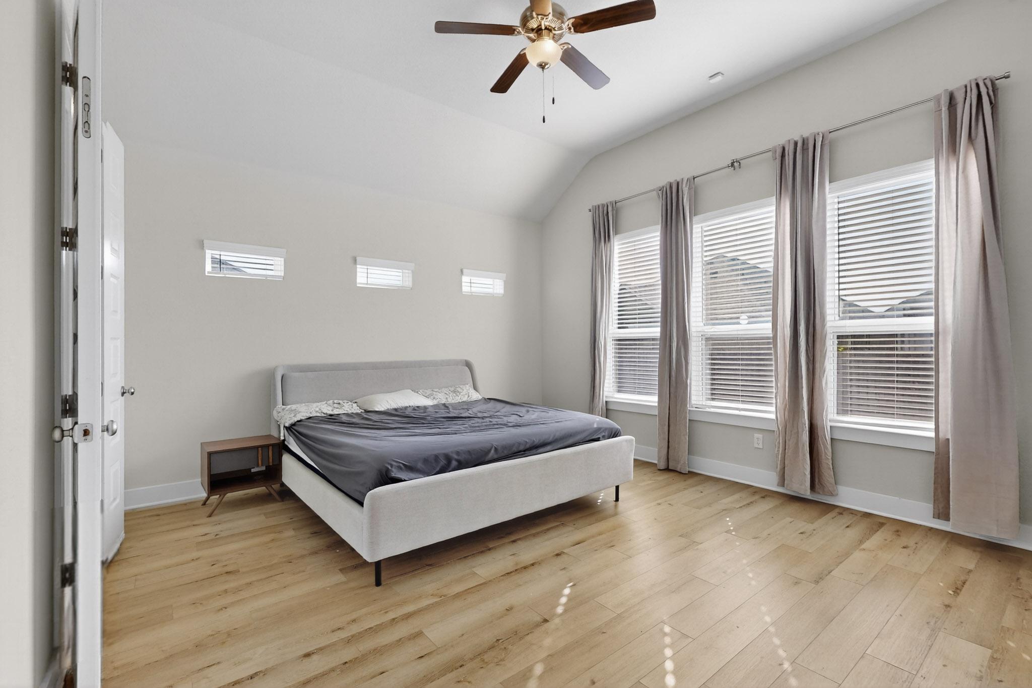20912 Carries Ranch Road Pflugerville, TX 78660 - Photo 12 of 20 High vaulted ceilings and rich wood floors define this light-filled bedroom retreat.