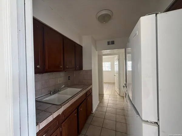 a kitchen with a refrigerator and a sink