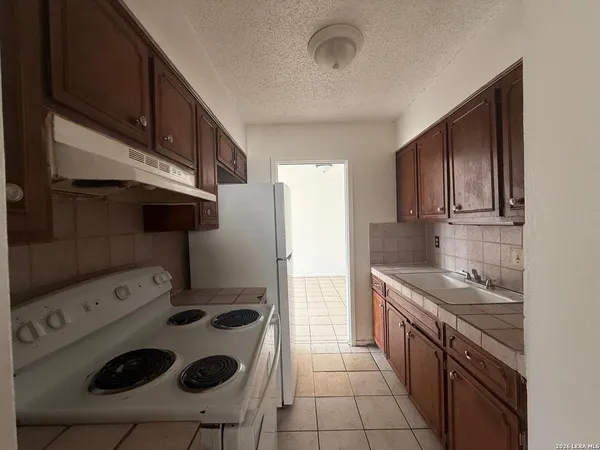 a kitchen with a stove and a refrigerator