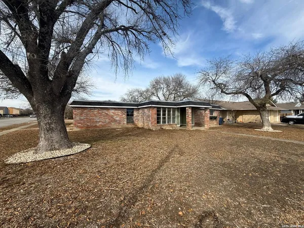 a view of a house with large trees