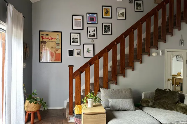 a living room with furniture and stairs