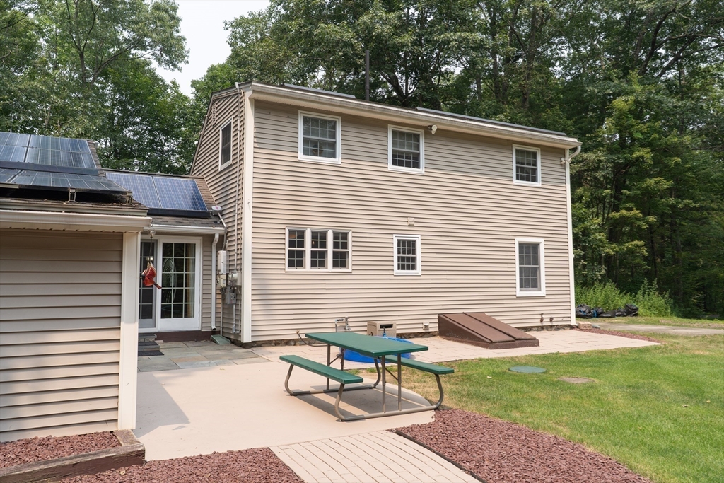 42 Oxbow Road Charlton, MA 01507 - Photo 32 of 42 a backyard of a house with outdoor seating