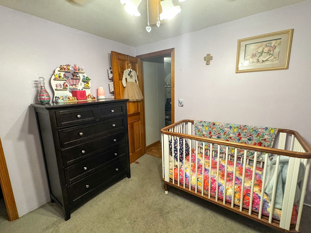 42 Oxbow Road Charlton, MA 01507 - Photo 42 of 42 a bedroom with furniture and a baby crib