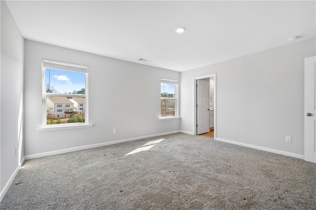 4646 Waxwing Street Hoschton, GA 30548 - Photo 17 of 36 a view of an empty room with a window