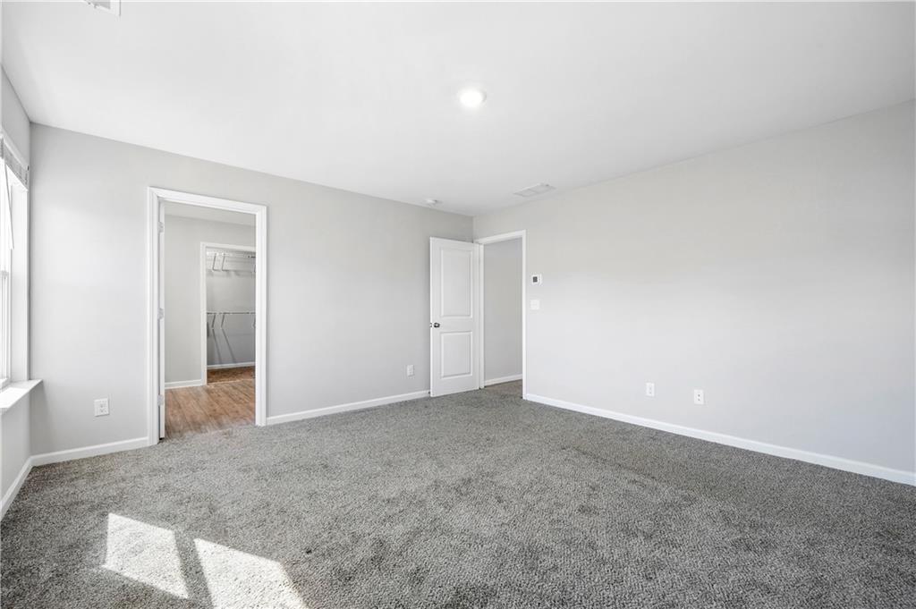 4646 Waxwing Street Hoschton, GA 30548 - Photo 18 of 36 an empty room with an entryway
