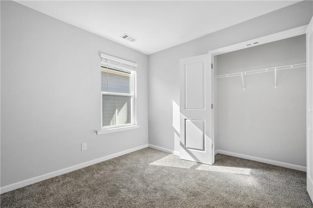 4646 Waxwing Street Hoschton, GA 30548 - Photo 23 of 36 a view of an empty room with a window