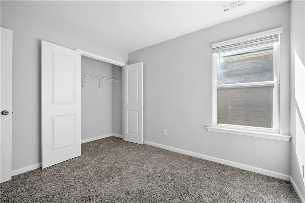 4646 Waxwing Street Hoschton, GA 30548 - Photo 25 of 36 a view of an empty room with a window