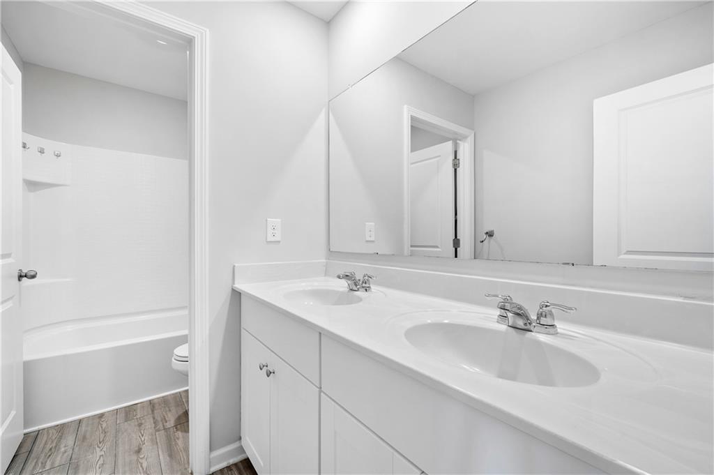 4646 Waxwing Street Hoschton, GA 30548 - Photo 27 of 36 a bathroom with a sink and a bathtub