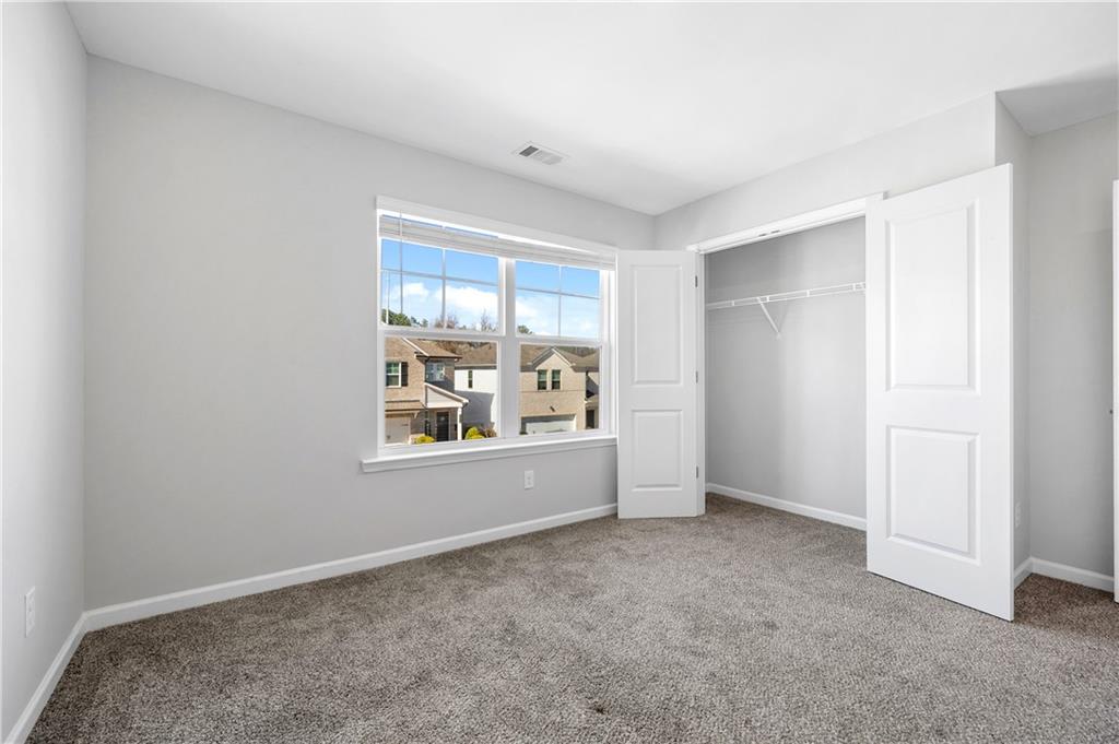 4646 Waxwing Street Hoschton, GA 30548 - Photo 29 of 36 a view of an empty room with window