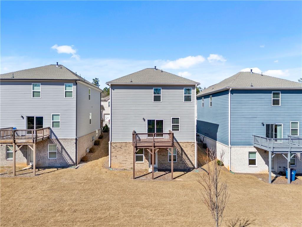 4646 Waxwing Street Hoschton, GA 30548 - Photo 3 of 36 a view of a house with backyard and sitting area