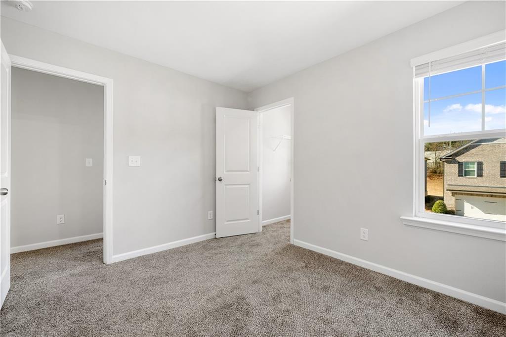 4646 Waxwing Street Hoschton, GA 30548 - Photo 32 of 36 a view of an empty room with a window