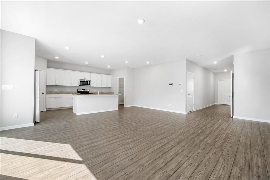 4646 Waxwing Street Hoschton, GA 30548 - Photo 7 of 36 a view of kitchen with wooden floor