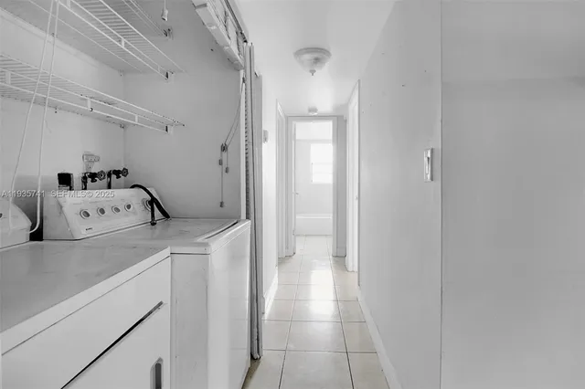 a utility room with cabinets washer and dryer