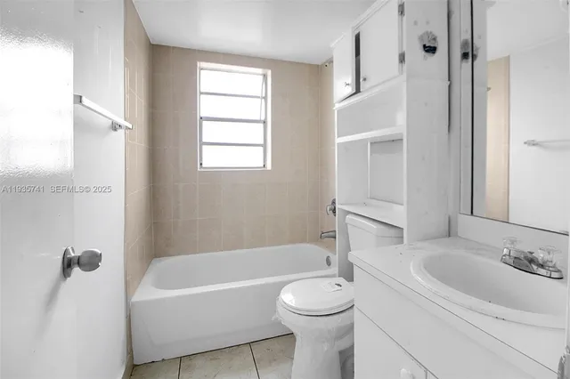 a bathroom with a toilet a sink and bathtub