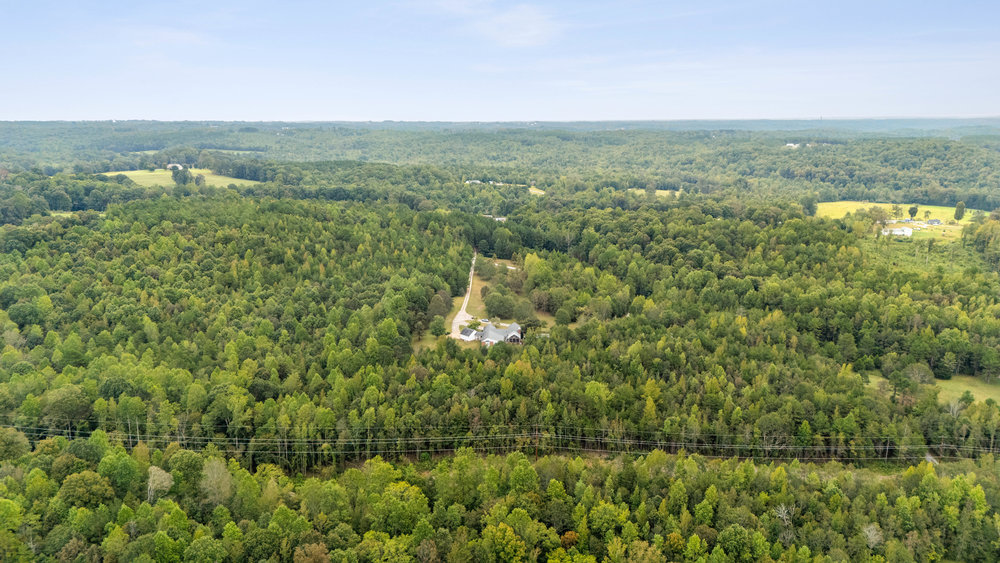 0 South Retreat Road Westminster, SC 29693 - Photo 1 of 3 An aerial view showcases a residence nestled within a vast, verdant landscape.