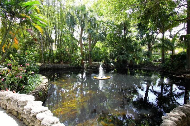 157 Yacht Club Way, Unit 201 CORNER Hypoluxo, FL 33462 - Photo 18 of 24 a view of a lake with large trees