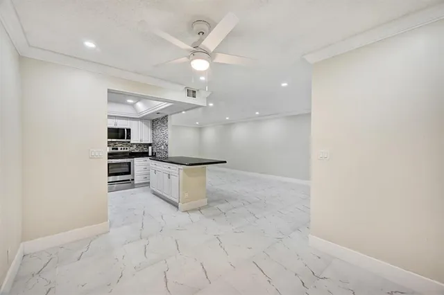 a view of a kitchen with a sink and cabinets