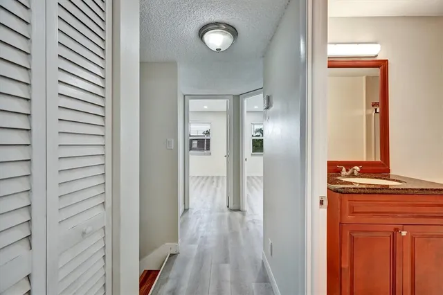 a view of a hallway with wooden floor