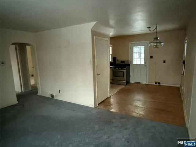 an empty room with closet and windows