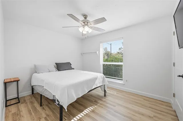 a bedroom with a large bed and a window