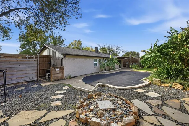 a backyard of a house with yard and outdoor seating