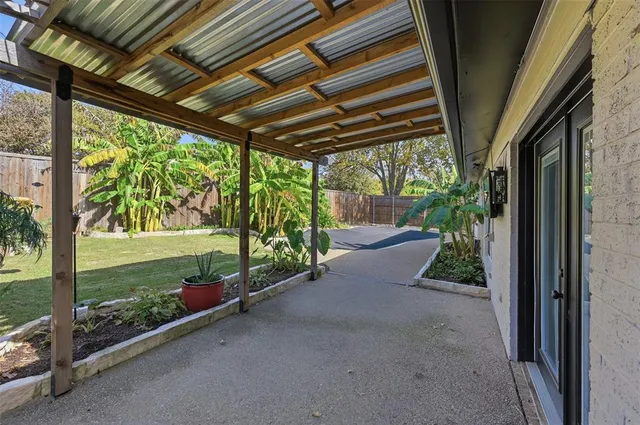 a view of a porch with furniture and a backyard
