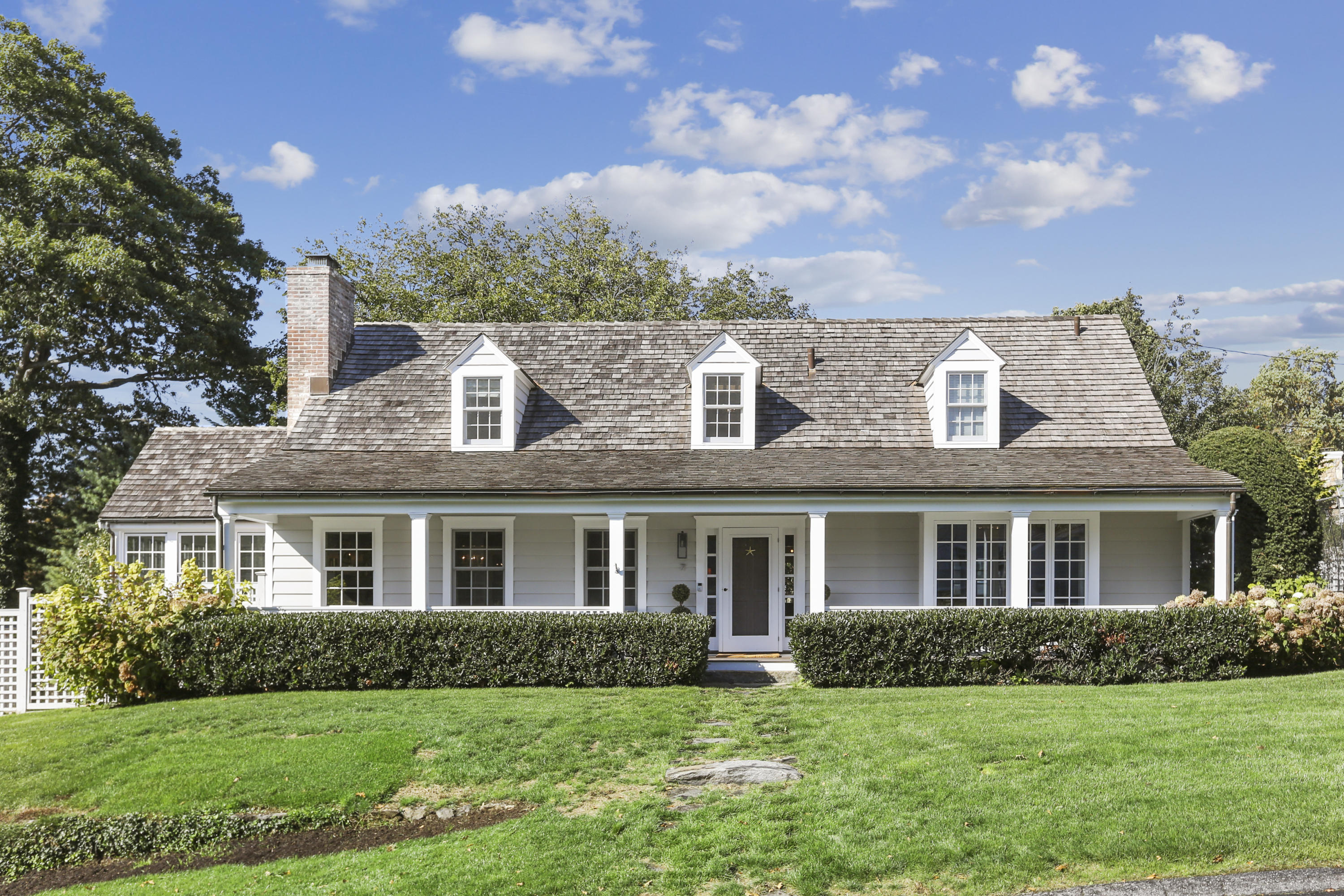 a front view of a house with a garden