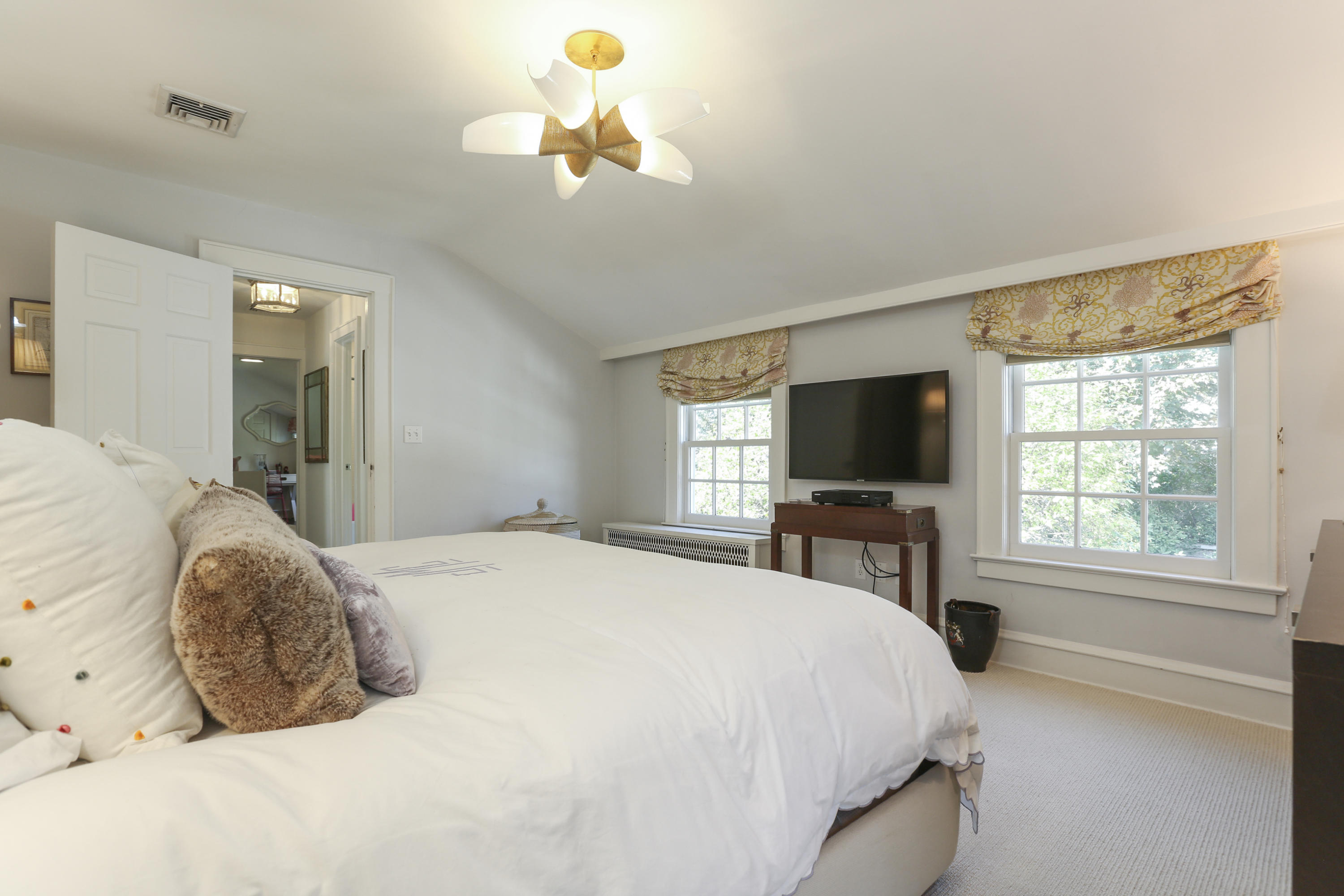 7 Bryan Road Norwalk, CT 06853 - Photo 25 of 37 a spacious bedroom with a bed and a flat screen tv