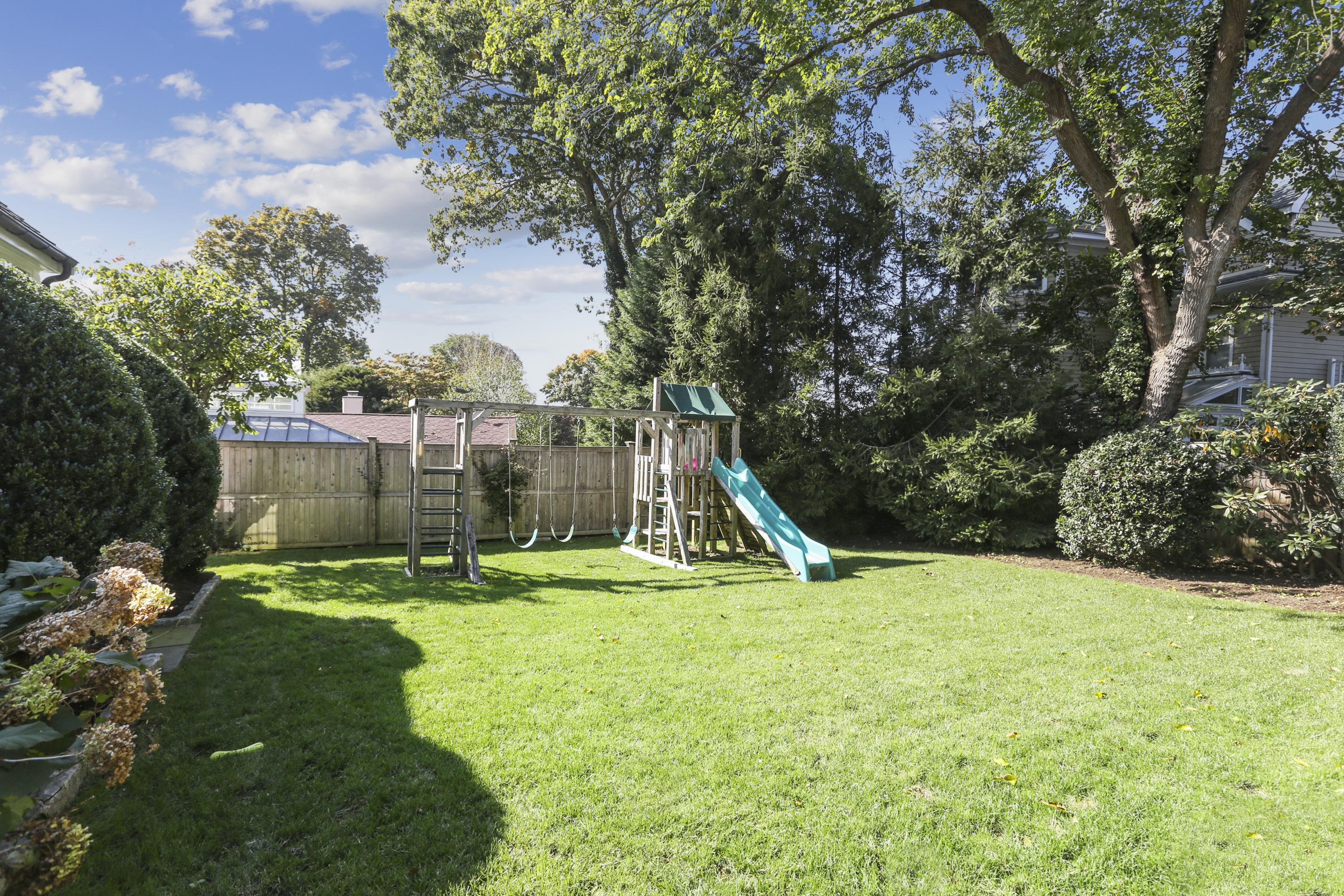 7 Bryan Road Norwalk, CT 06853 - Photo 35 of 37 a view of a garden with a slide and a tree