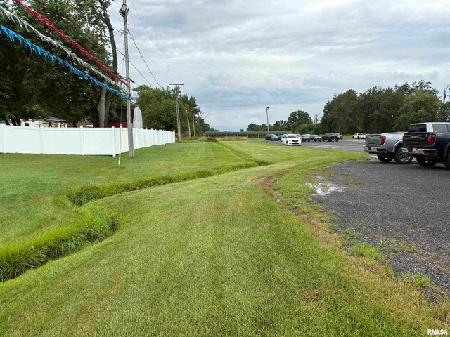 a view of yard with house and car parked