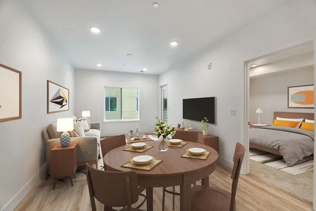 a view of a dining room with furniture and wooden floor