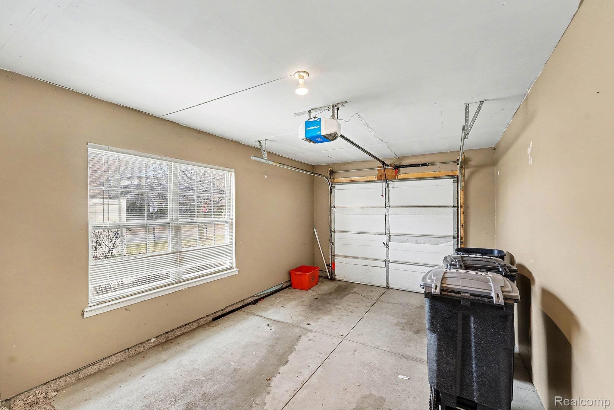 11712 Farmington Road Livonia, MI 48150 - Photo 13 of 13 Garage featuring a garage door opener