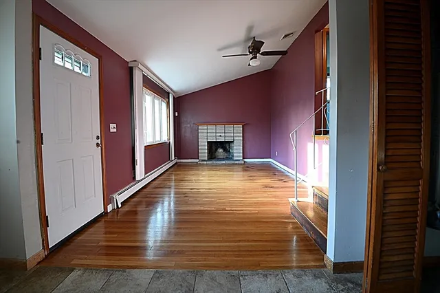 a room with wooden floor and windows