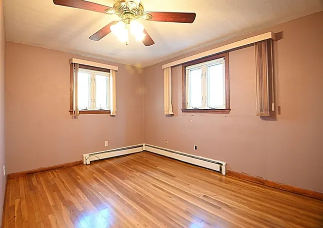 wooden floor in an empty room with a window