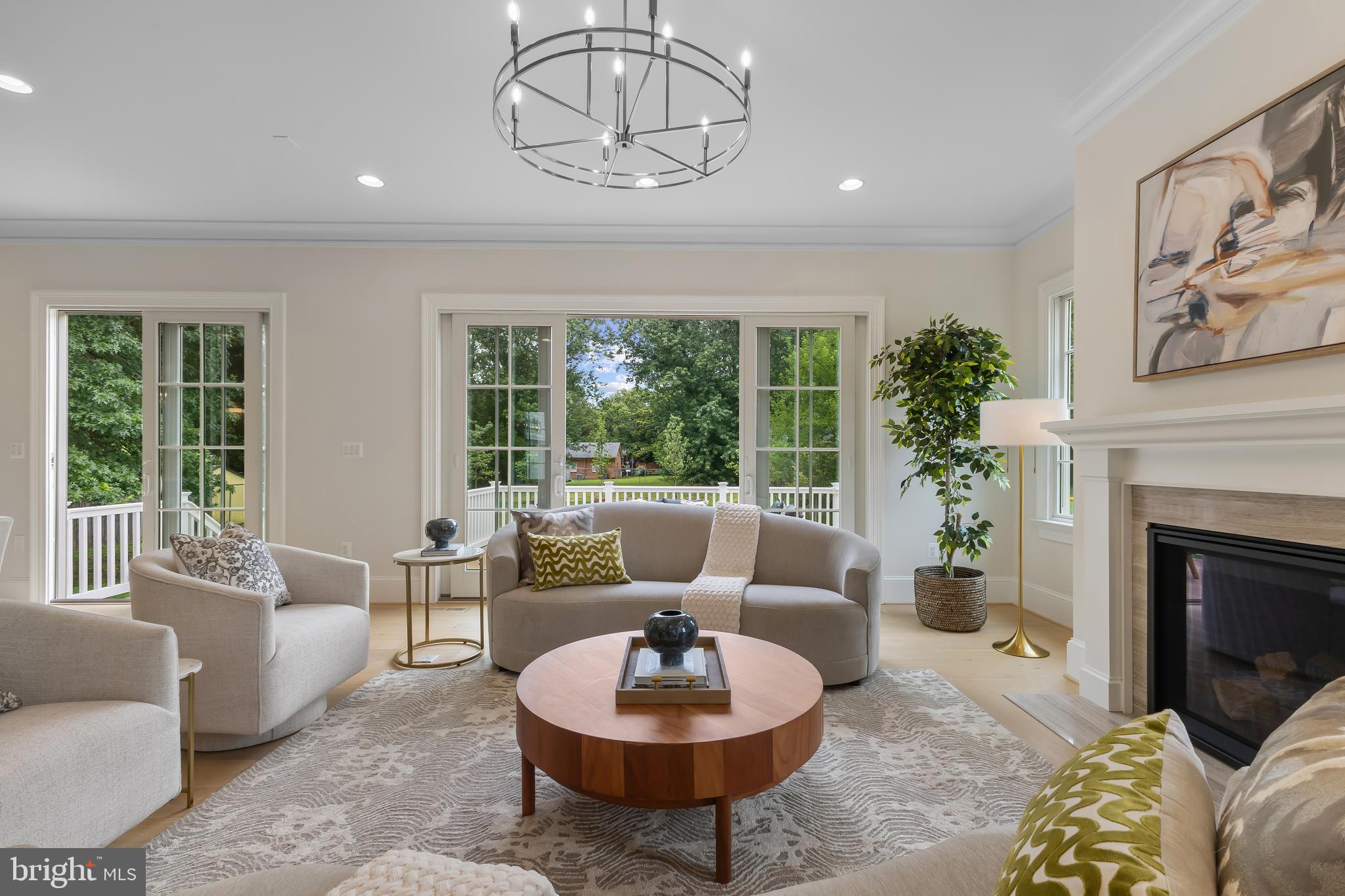 8628 Plymouth Road Alexandria, VA 22308 - Photo 13 of 50 a living room with furniture a fireplace and a large window