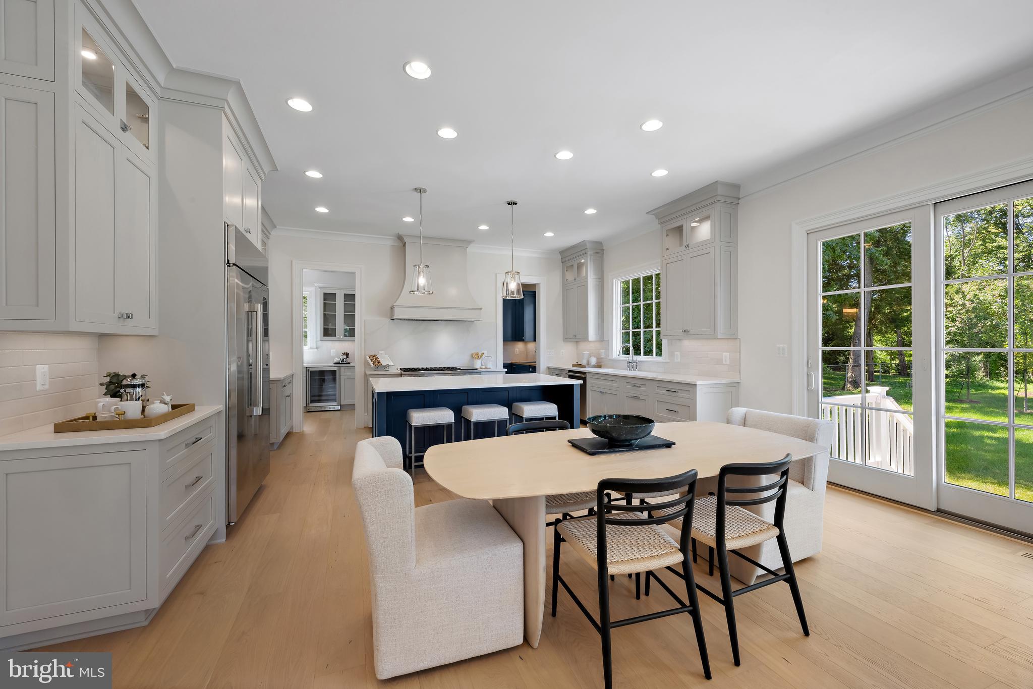 8628 Plymouth Road Alexandria, VA 22308 - Photo 15 of 50 a kitchen with a table chairs stove and kitchen island